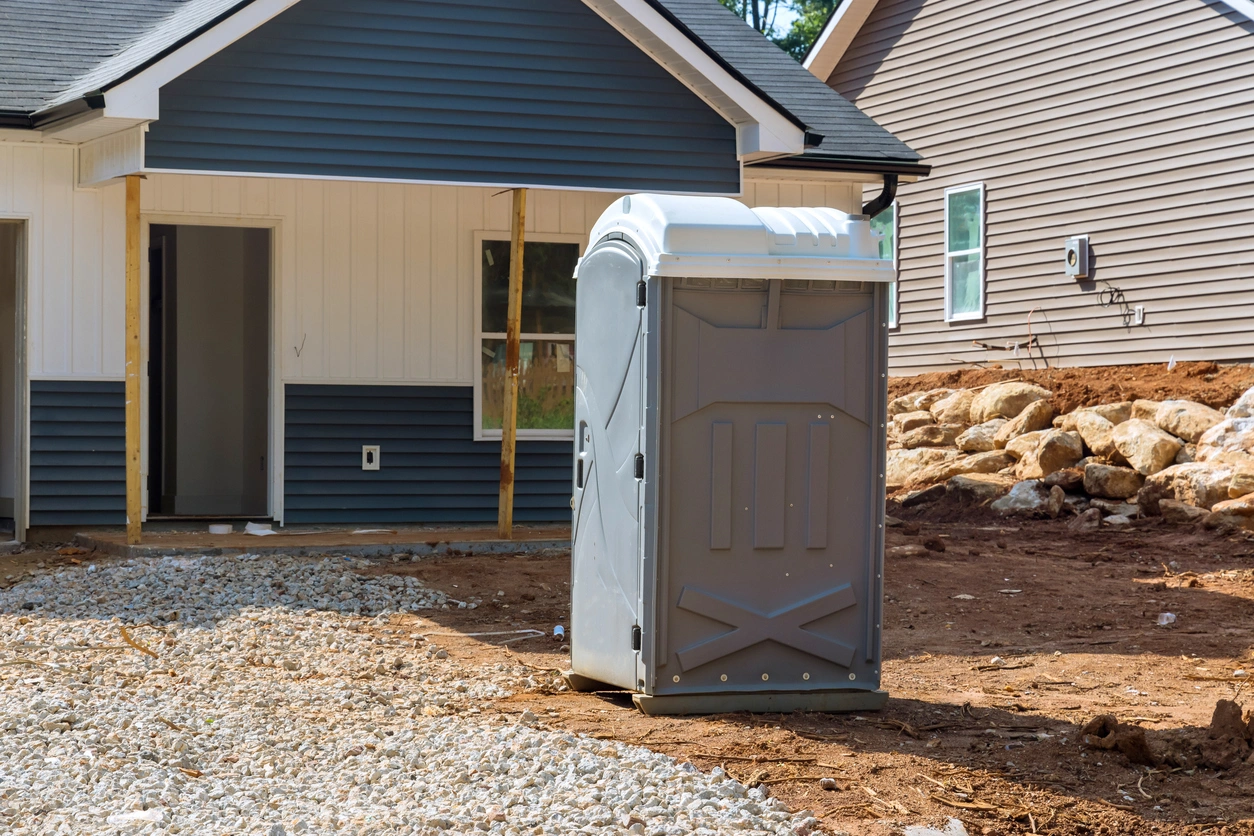 porta potty outside of a house under construction